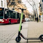 Grüner E-Scooter Tier parkt auf dem Gehsteig.
