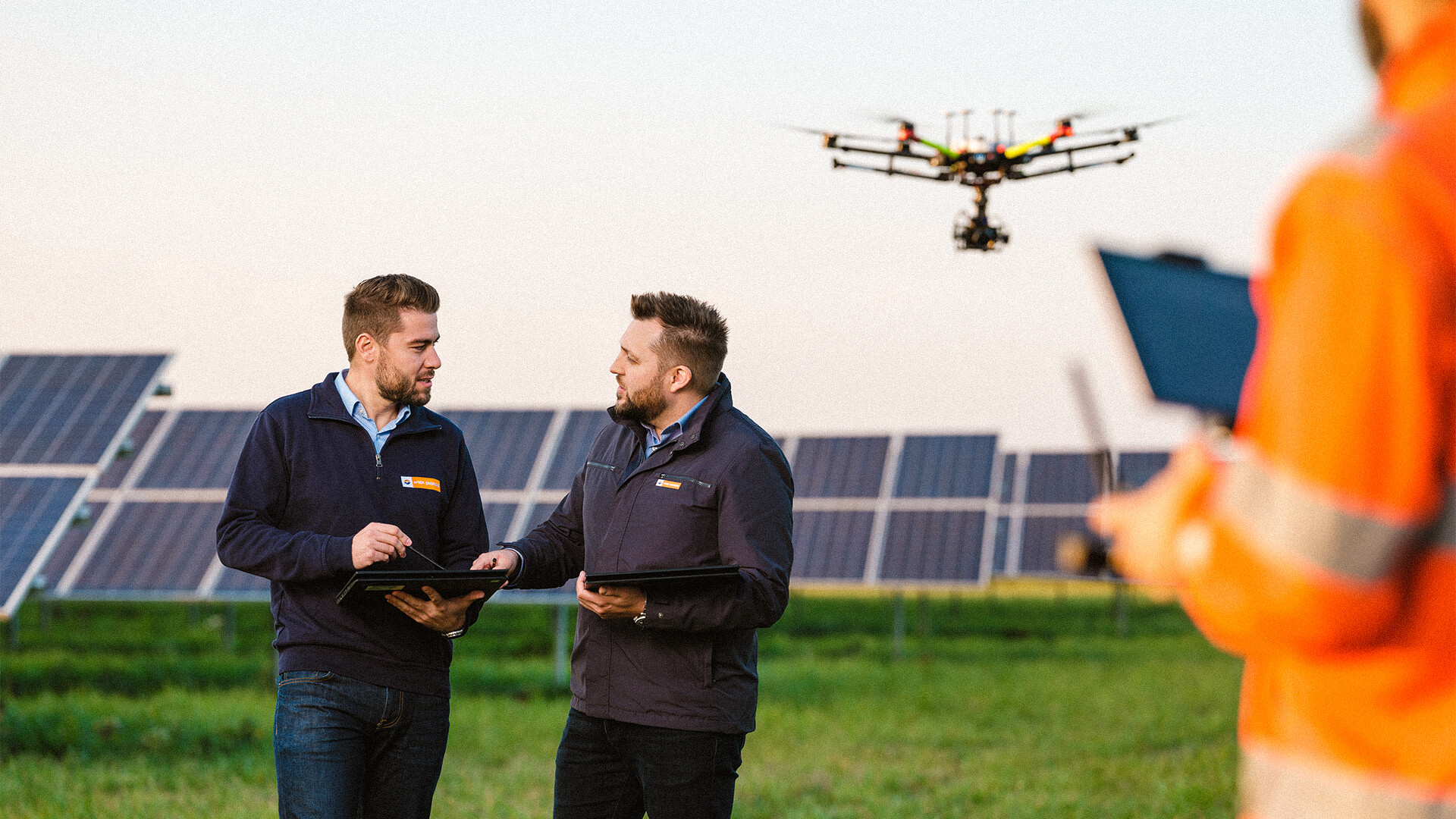 Mitarbeiter bei der Drohnenwartung von einer Photovoltaik-Anlage.