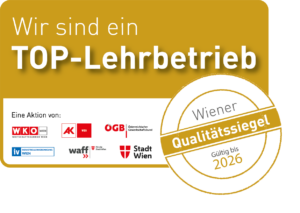 Badge mit der Aufschrift "Wir sind ein TOP-Lehrlingsbetrieb" von Wiener Qualitätssiegel gültig bis 2026